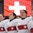 PLYMOUTH, MICHIGAN - MARCH 31: Team Switzerland's flag in the background during the playing of their national anthem following a 2-1 shootout win over team Czech Republic during preliminary round action at the 2017 IIHF Ice Hockey Women's World Championship. (Photo by Minas Panagiotakis/HHOF-IIHF Images)